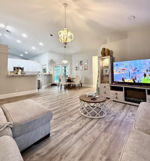 22392 Siesta Key Drive Boca Raton, FL 33428 - Photo 14 of 39 a living room with furniture kitchen view and a chandelier