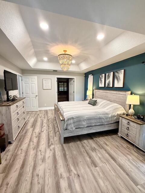 22392 Siesta Key Drive Boca Raton, FL 33428 - Photo 17 of 39 a bedroom with a large bed and a flat tv screen on dresser