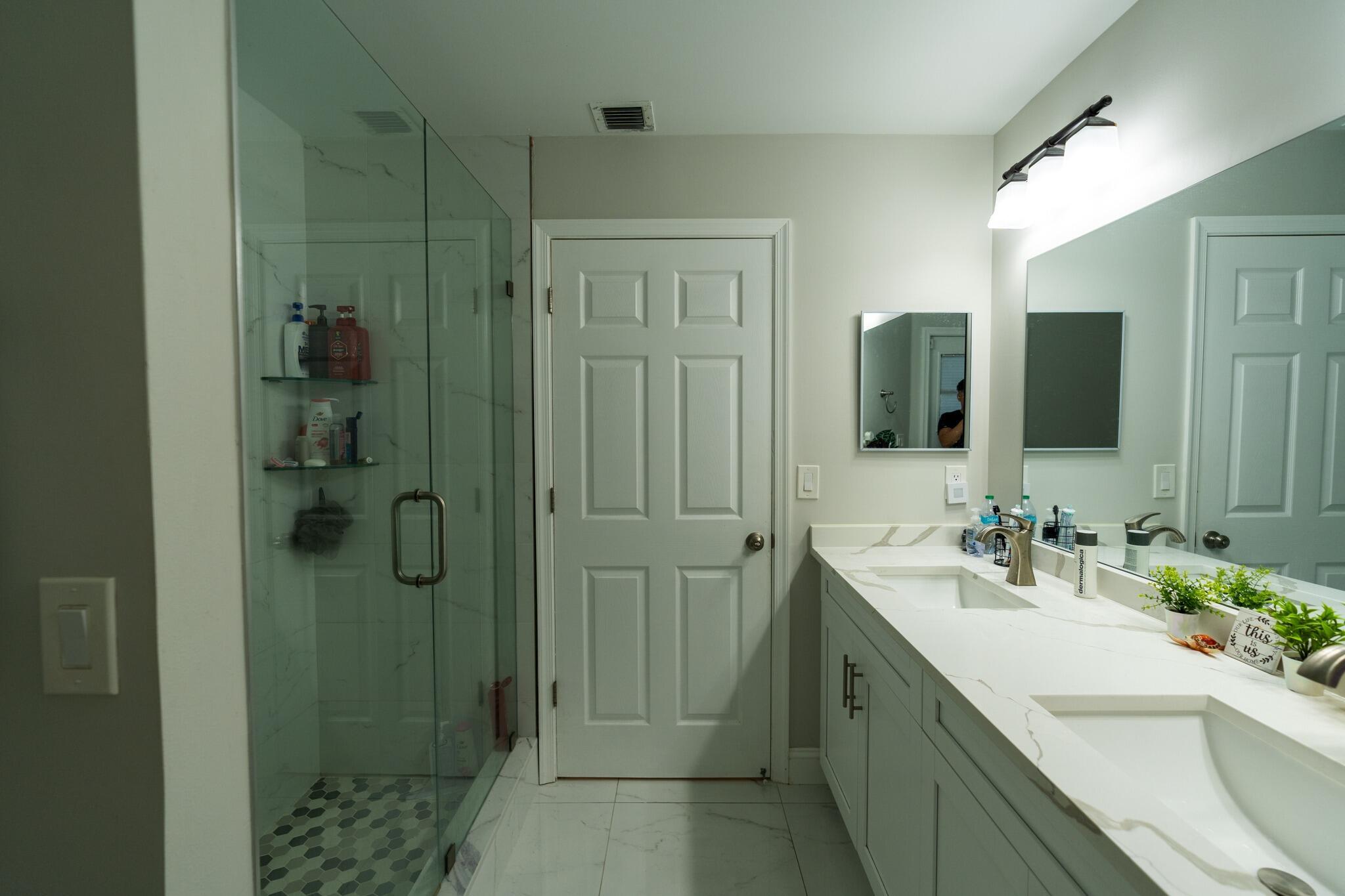 22392 Siesta Key Drive Boca Raton, FL 33428 - Photo 22 of 39 a bathroom with a double vanity sink shower and mirror