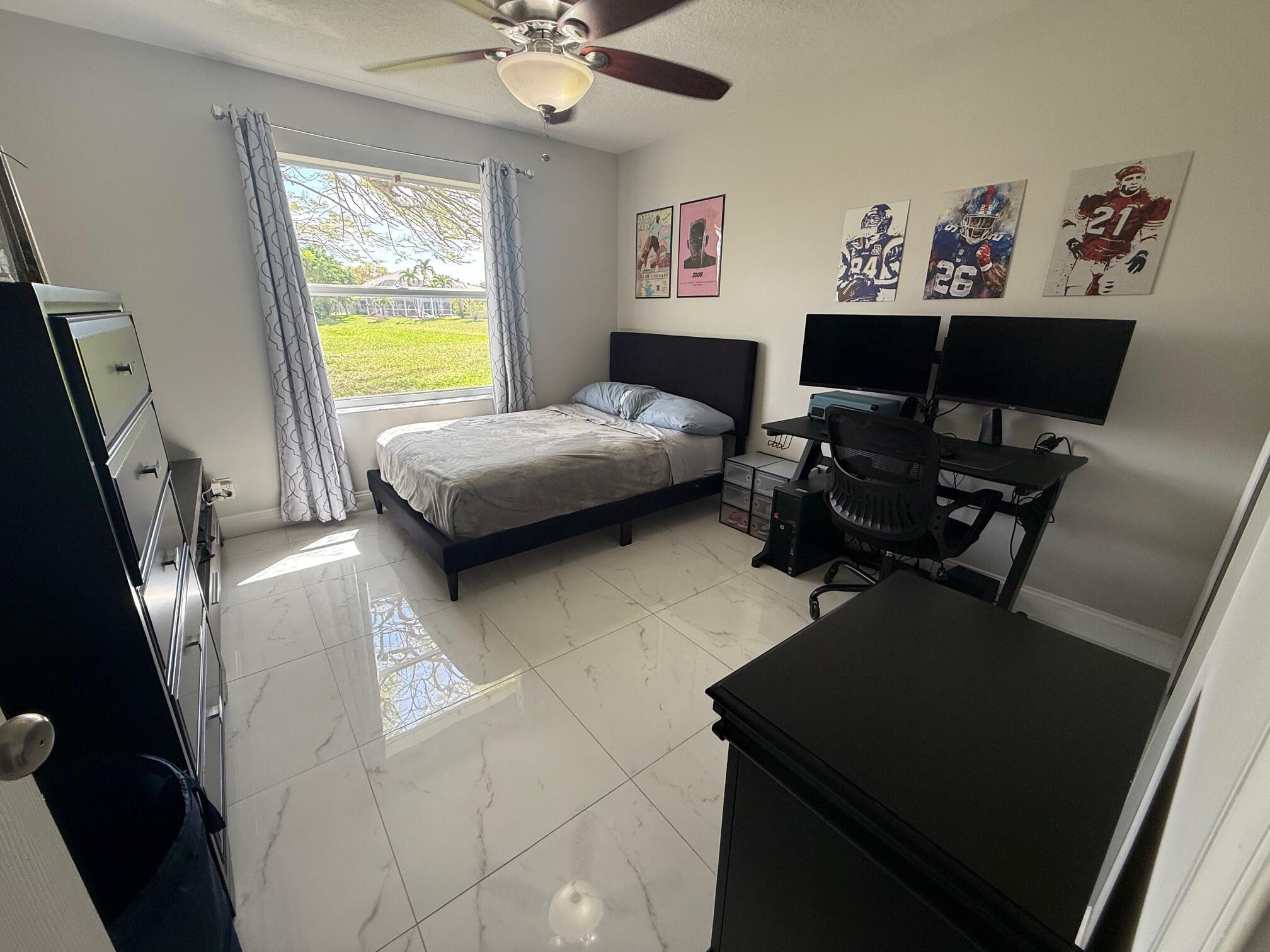 22392 Siesta Key Drive Boca Raton, FL 33428 - Photo 24 of 39 a living room with furniture and a flat screen tv