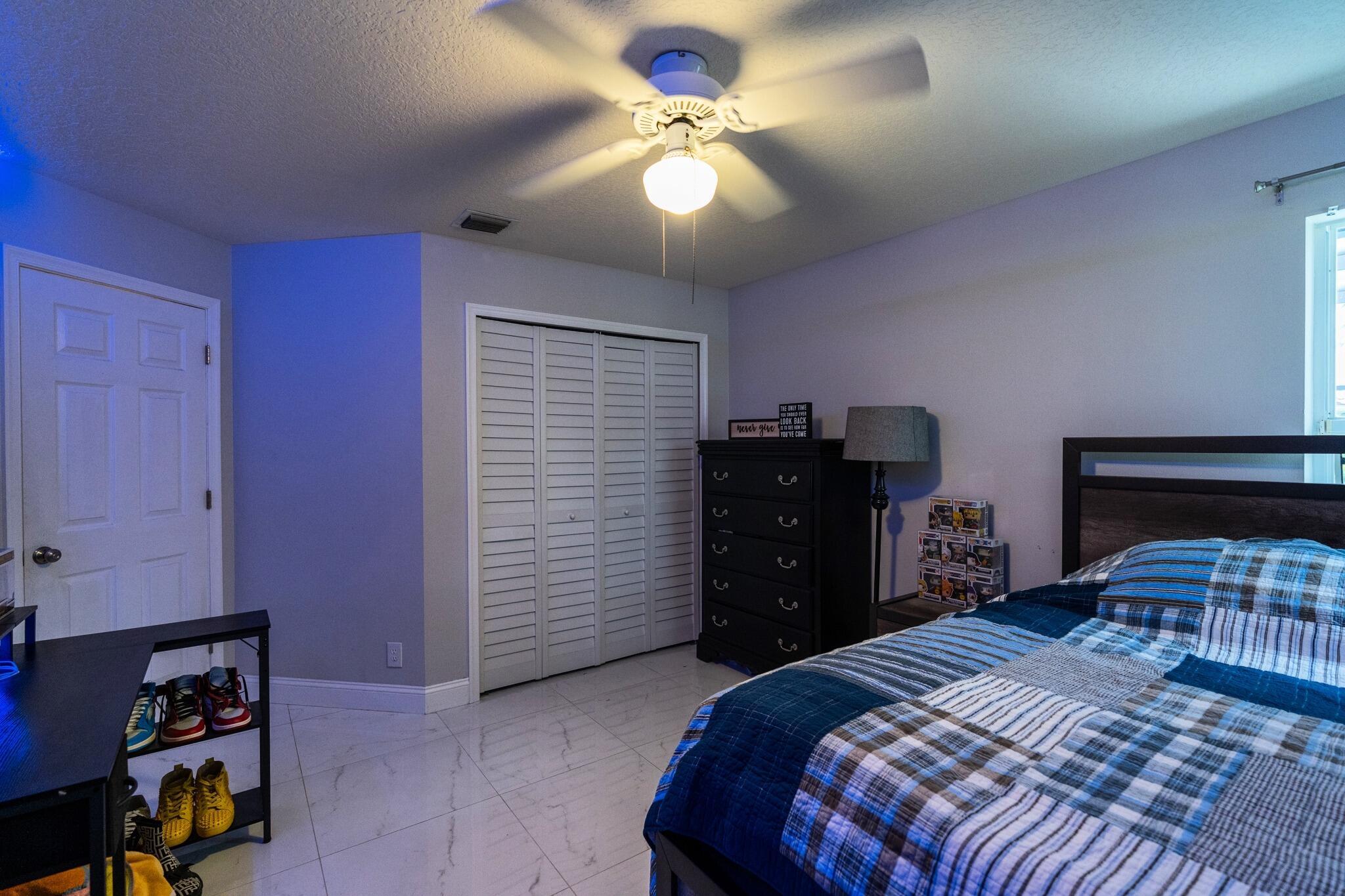 22392 Siesta Key Drive Boca Raton, FL 33428 - Photo 25 of 39 a bedroom with a bed and a chandelier