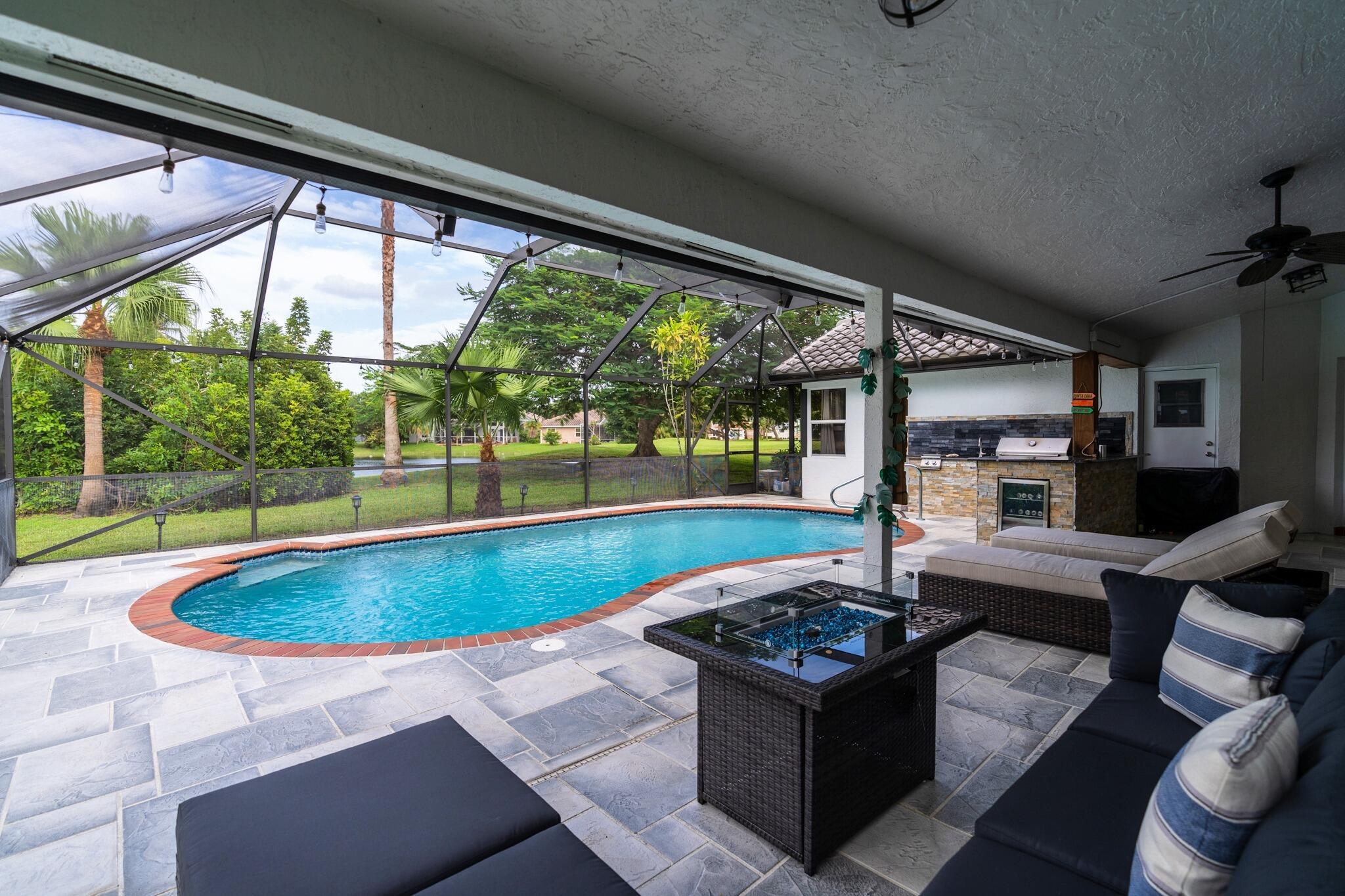 22392 Siesta Key Drive Boca Raton, FL 33428 - Photo 30 of 39 a kitchen with a stove and a view of living room