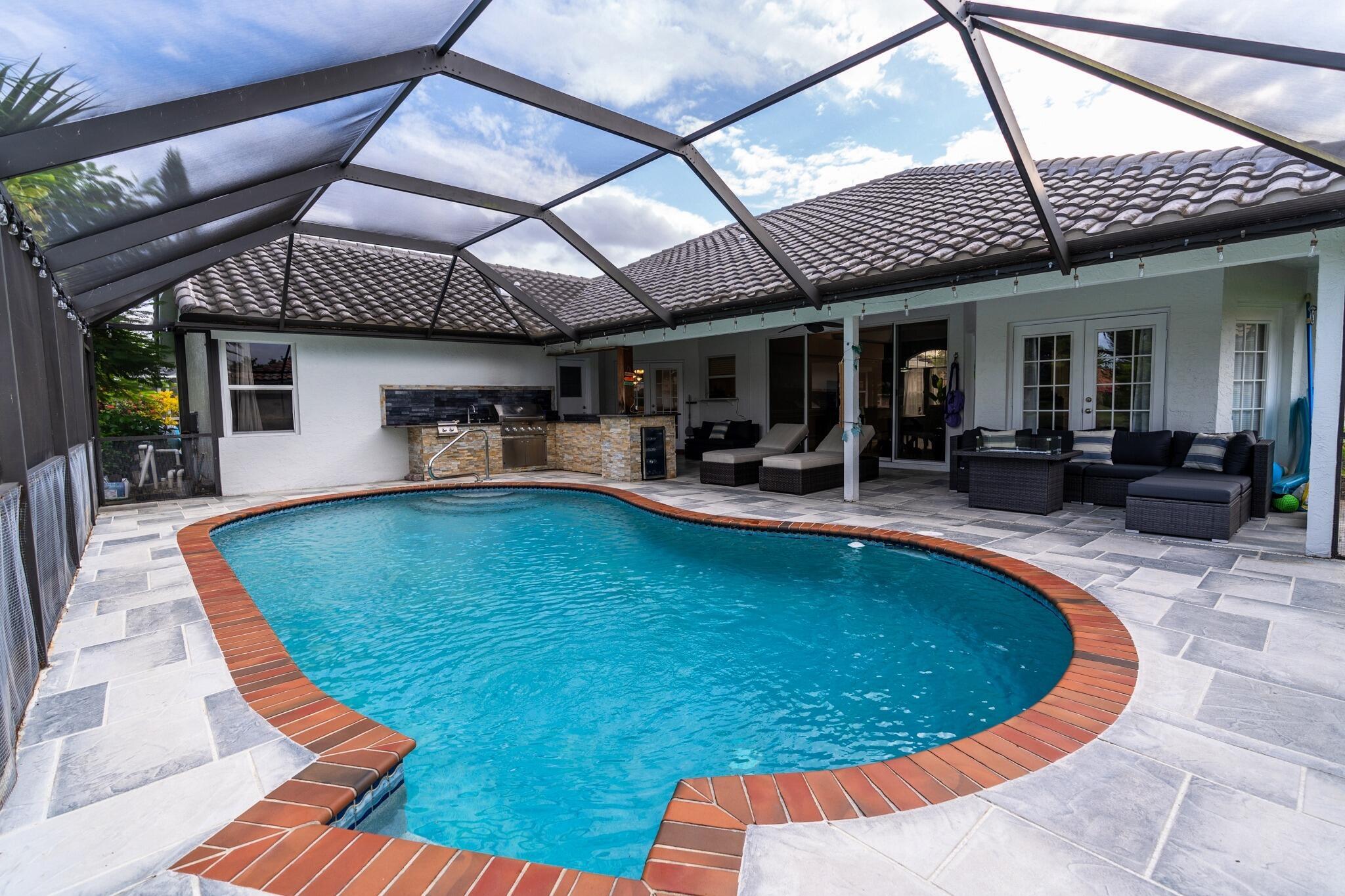 22392 Siesta Key Drive Boca Raton, FL 33428 - Photo 31 of 39 a view of a swimming pool with a patio
