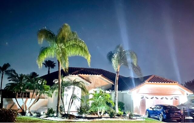 22392 Siesta Key Drive Boca Raton, FL 33428 - Photo 36 of 39 a vase of flowers sitting on a table with chairs
