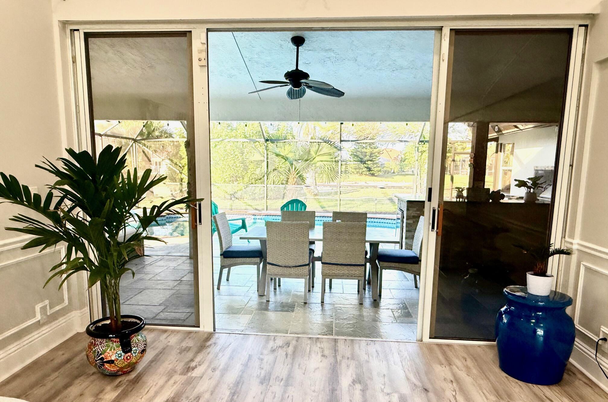 22392 Siesta Key Drive Boca Raton, FL 33428 - Photo 8 of 39 a living room with furniture and a floor to ceiling window
