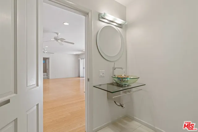 a view of a kitchen with kitchen island a sink stainless steel appliances and cabinets