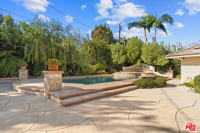 a patio with a patio table and chairs