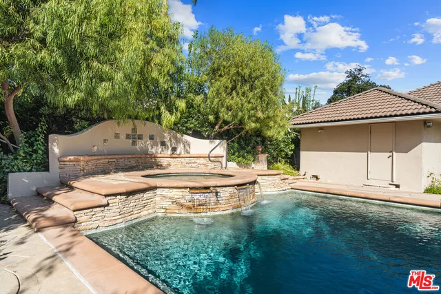 a view of an empty room with a cabinet and a window