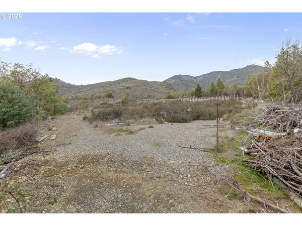 a view of a dry yard with mountain