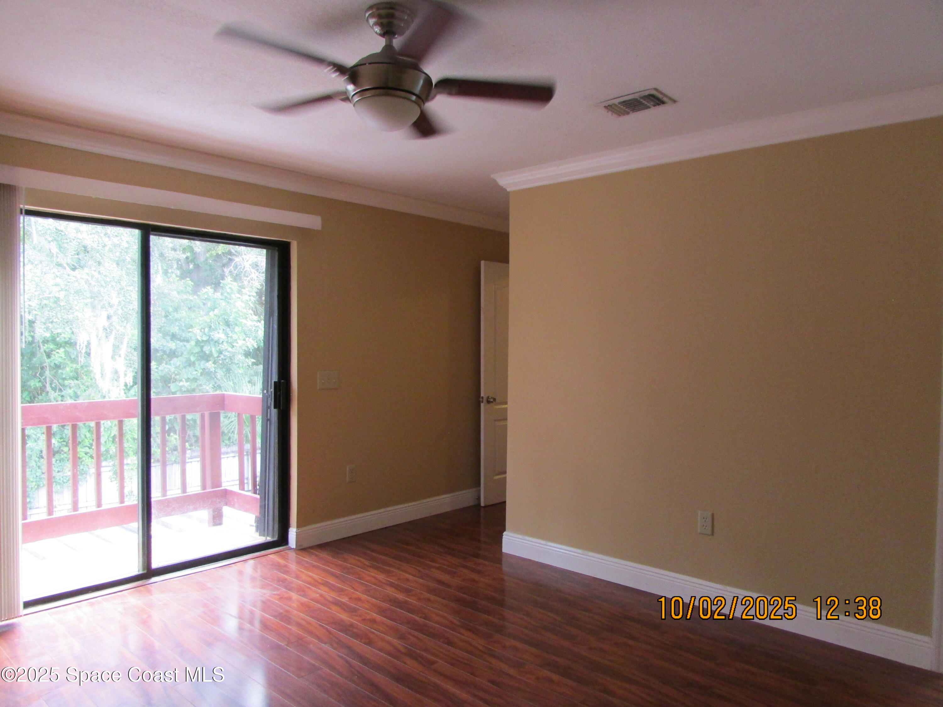 49 Piney Branch Way, Unit A Melbourne, FL 32904 - Photo 14 of 25 wooden floor in an empty room with a window
