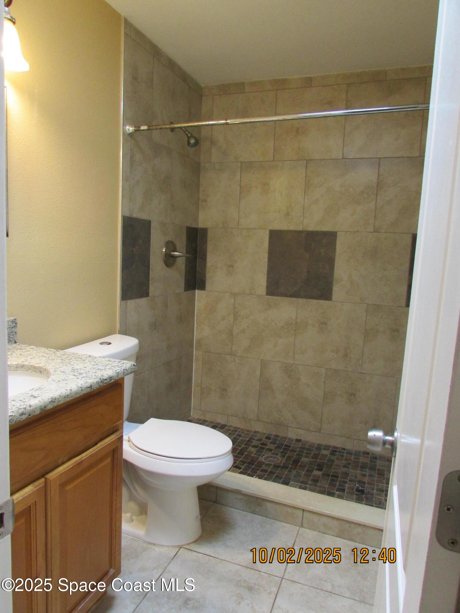 49 Piney Branch Way, Unit A Melbourne, FL 32904 - Photo 15 of 25 a bathroom with a shower and a toilet