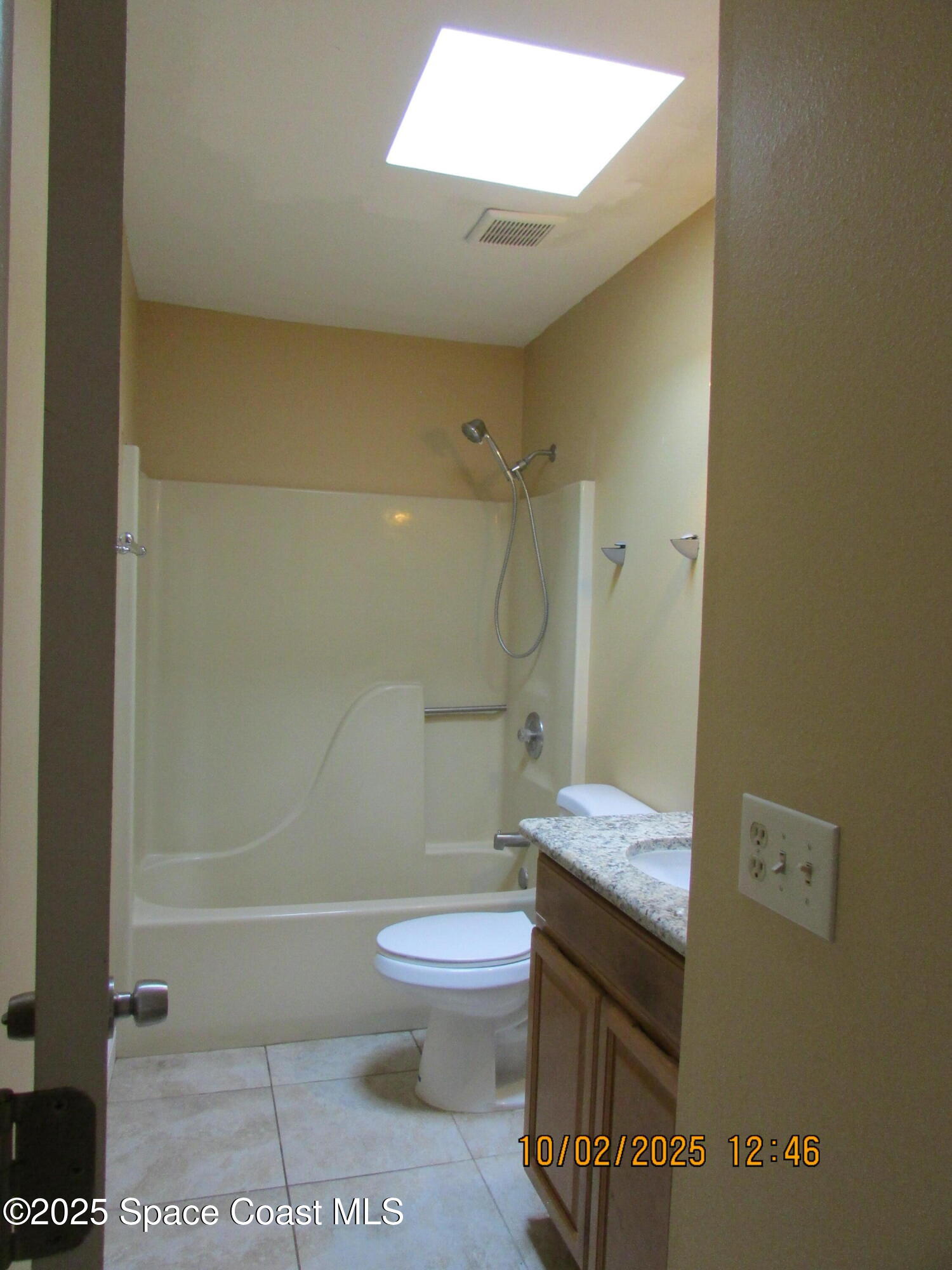 49 Piney Branch Way, Unit A Melbourne, FL 32904 - Photo 20 of 25 a bathroom with a granite countertop toilet a sink and shower
