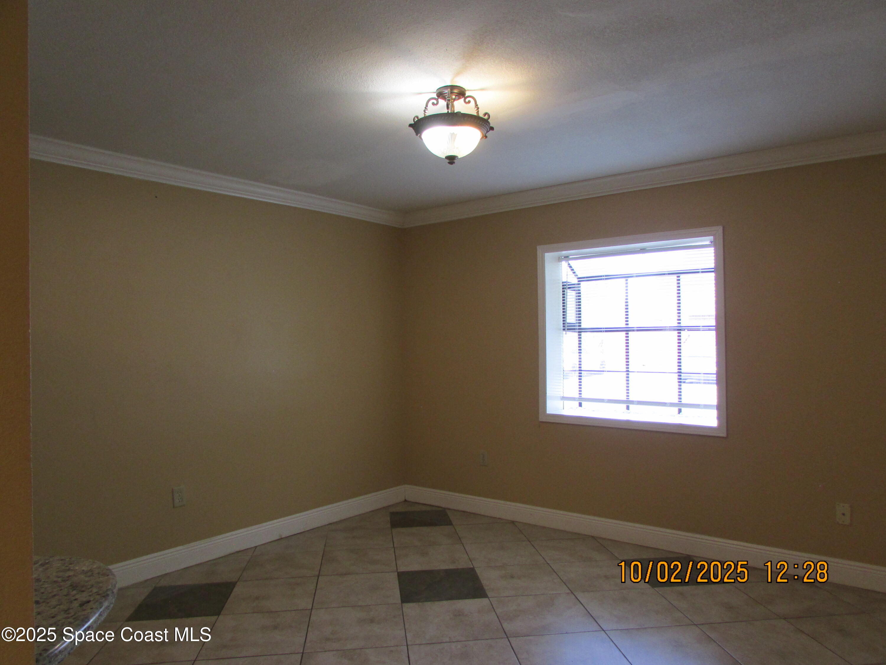 49 Piney Branch Way, Unit A Melbourne, FL 32904 - Photo 3 of 25 an empty room with a window
