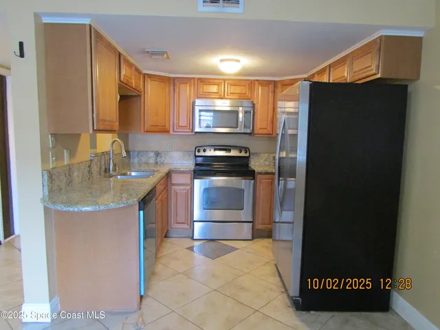 a kitchen with a refrigerator and a sink