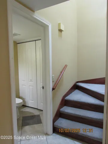a bathroom with a toilet a sink and a mirror