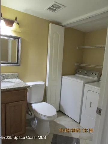 a bathroom with a toilet a sink and a mirror