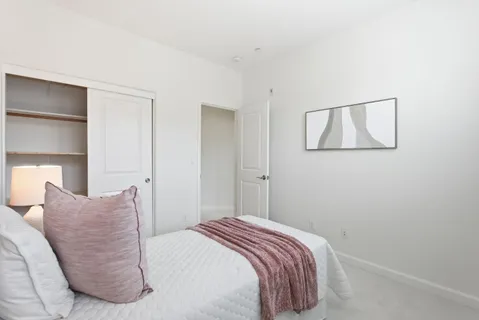 a bedroom with a bed and a lamp