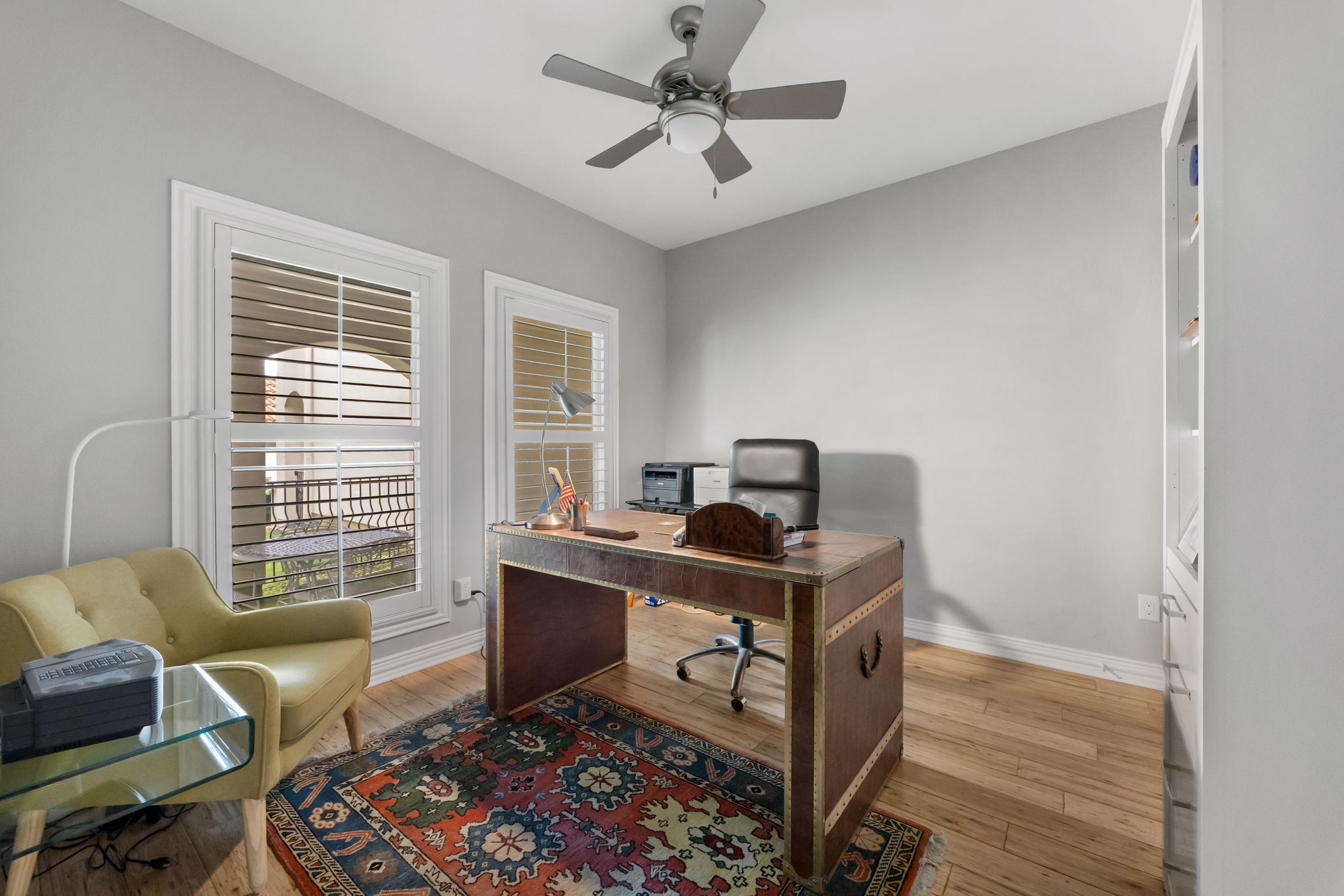 1910 Rue De St Tropez, Unit 6 Austin, TX 78746 - Photo 28 of 37 A refined study featuring wood floors and shuttered windows offers a comfortable work-from-home sanctuary.