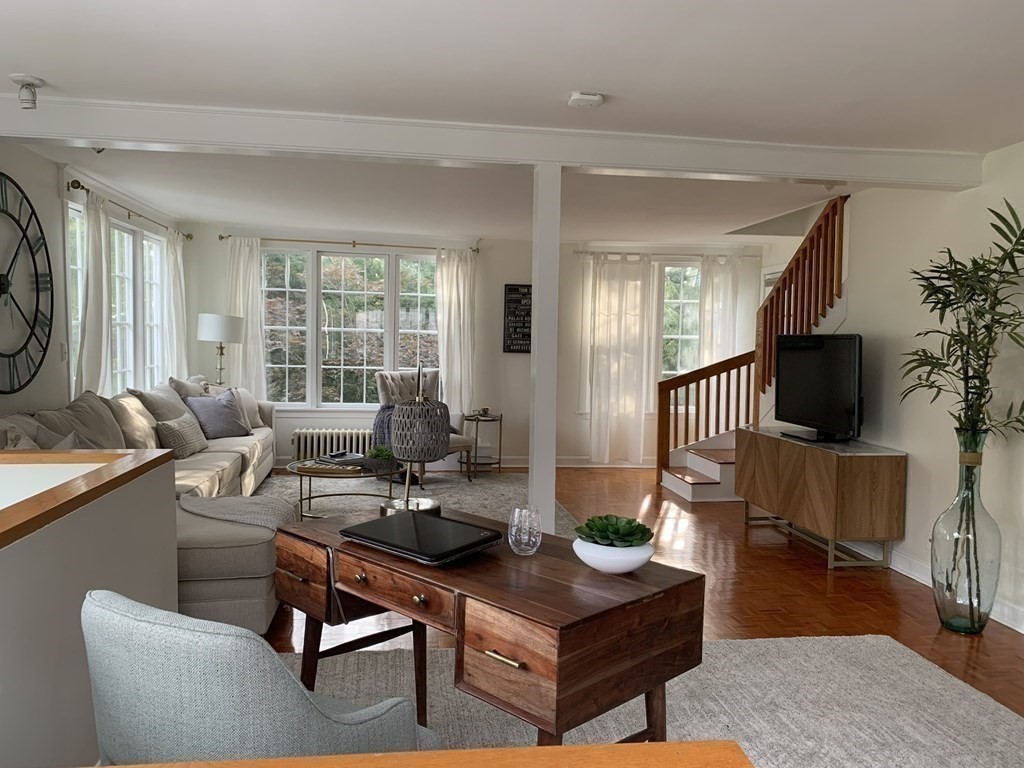 62 Pleasant Street Newton, MA 02459 - Photo 11 of 17 a living room with furniture a flat screen tv and a large window