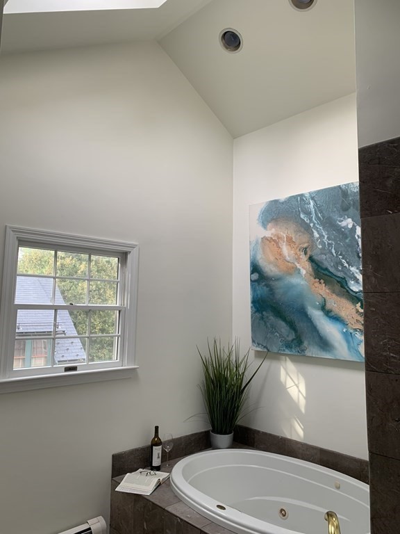 62 Pleasant Street Newton, MA 02459 - Photo 16 of 17 a bathroom with a toilet a sink and a window