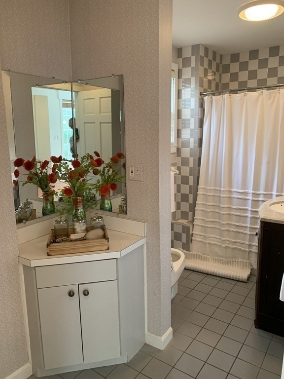 62 Pleasant Street Newton, MA 02459 - Photo 5 of 17 a bathroom with a sink and a mirror