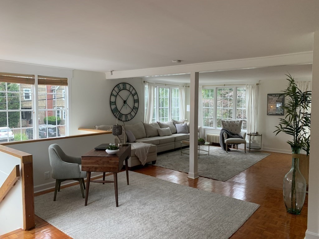 62 Pleasant Street Newton, MA 02459 - Photo 6 of 17 a living room with furniture a table and large windows