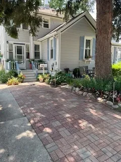 a front view of house with yard and trees around