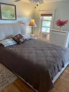a bedroom with a bed and a lamp on dresser
