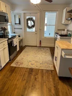 a view of a kitchen with microwave and cabinets