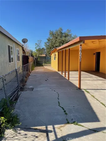 a backyard of a house with shaded area