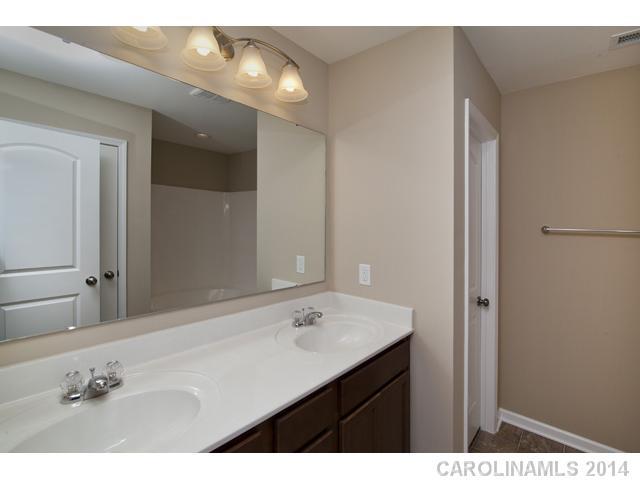 79369 Ridgehaven Road, Unit 26 Lancaster, SC 29720 - Photo 11 of 16 a bathroom with a sink vanity and a mirror