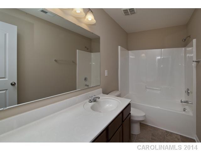 79369 Ridgehaven Road, Unit 26 Lancaster, SC 29720 - Photo 14 of 16 a bathroom with a sink shower and a mirror