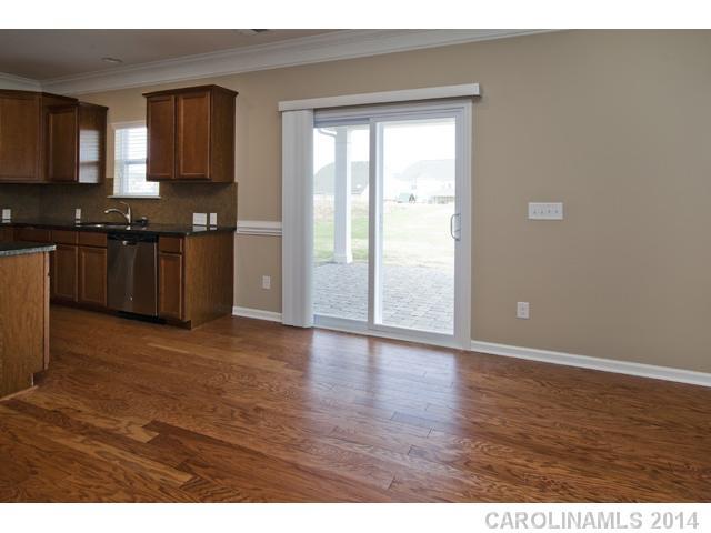 79369 Ridgehaven Road, Unit 26 Lancaster, SC 29720 - Photo 5 of 16 a view of kitchen with granite countertop cabinets and wooden floor