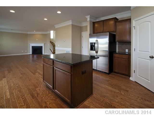 79369 Ridgehaven Road, Unit 26 Lancaster, SC 29720 - Photo 8 of 16 a kitchen with kitchen island sink refrigerator and microwave