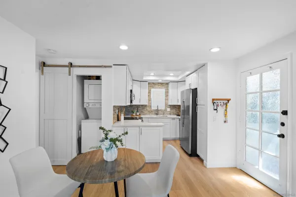 a kitchen with refrigerator and table