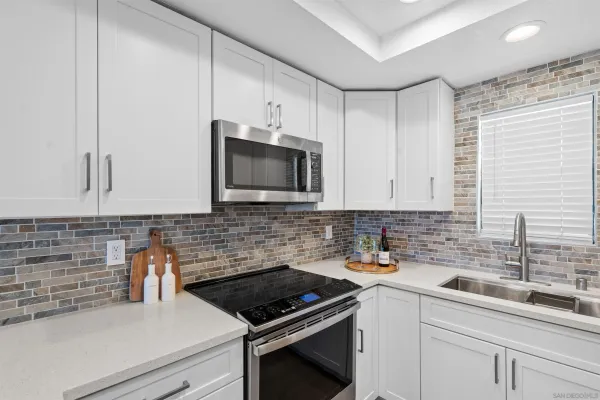 a kitchen with a sink and cabinets