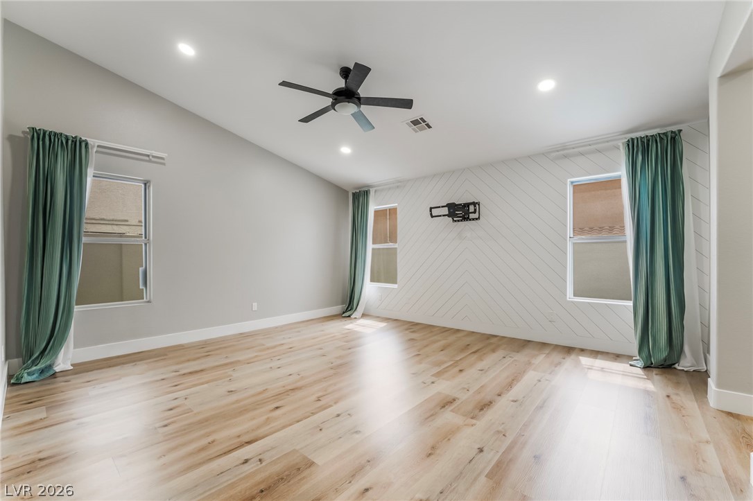 9171 West Viking Road Las Vegas, NV 89147 - Photo 30 of 43 Wood flooring and vaulted ceilings frame this versatile space, perfect for any use.