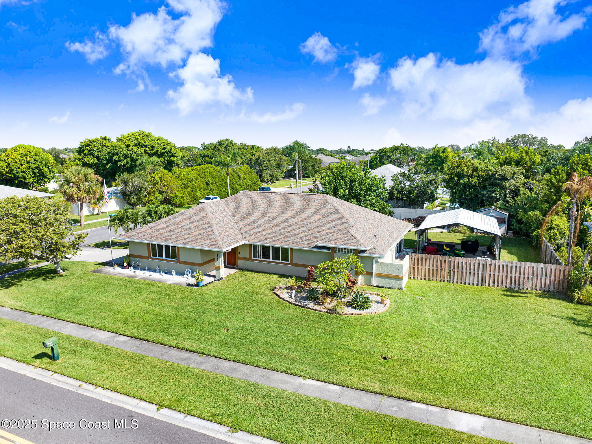 a aerial view of a house with garden space and street view