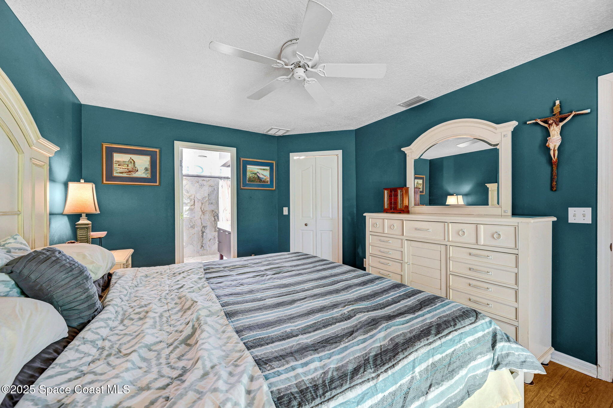 1507 Meadowbrook Road Northeast Palm Bay, FL 32905 - Photo 11 of 50 a bedroom with a bed and a dresser