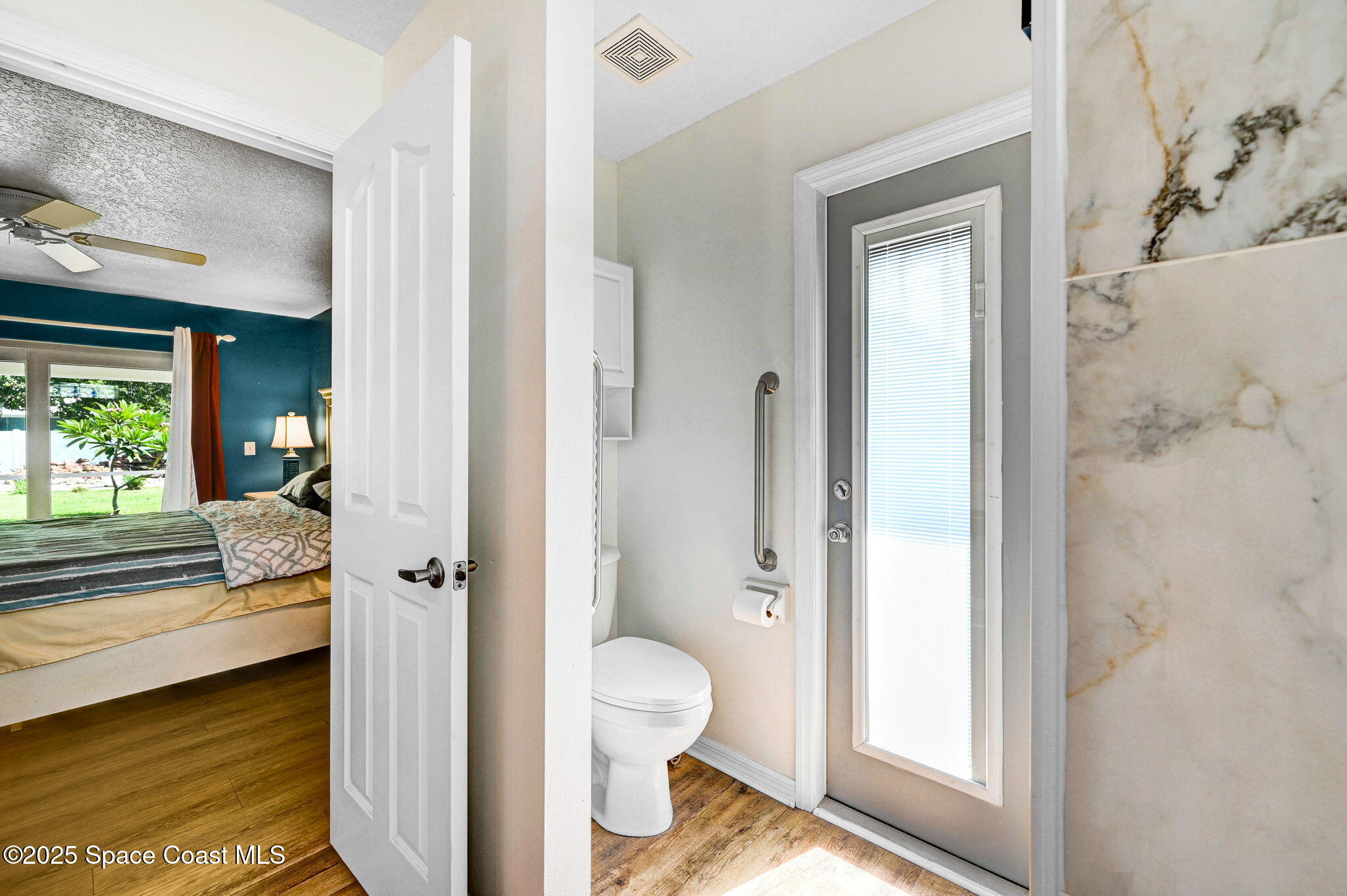 1507 Meadowbrook Road Northeast Palm Bay, FL 32905 - Photo 13 of 50 a bathroom with a granite countertop sink mirror and toilet