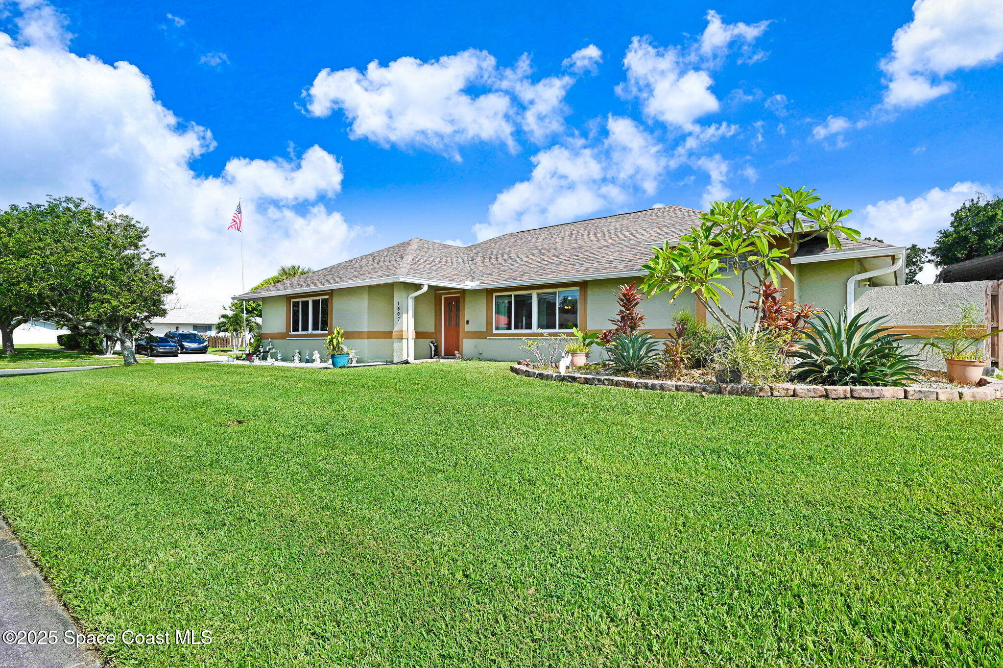 1507 Meadowbrook Road Northeast Palm Bay, FL 32905 - Photo 2 of 50 a front view of a house with garden