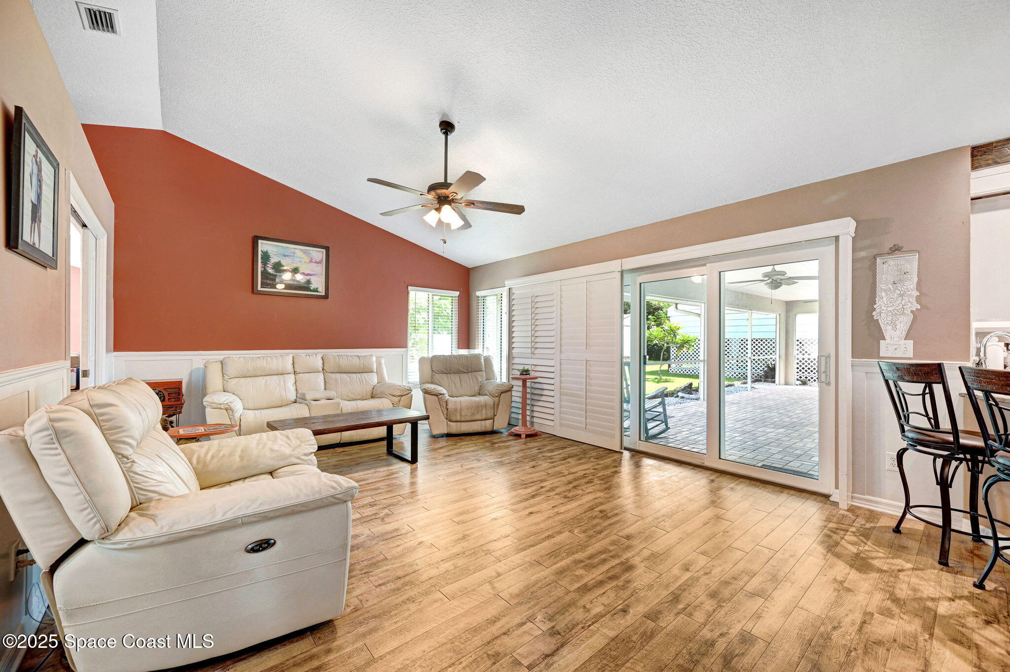 1507 Meadowbrook Road Northeast Palm Bay, FL 32905 - Photo 21 of 50 a living room with furniture and wooden floor