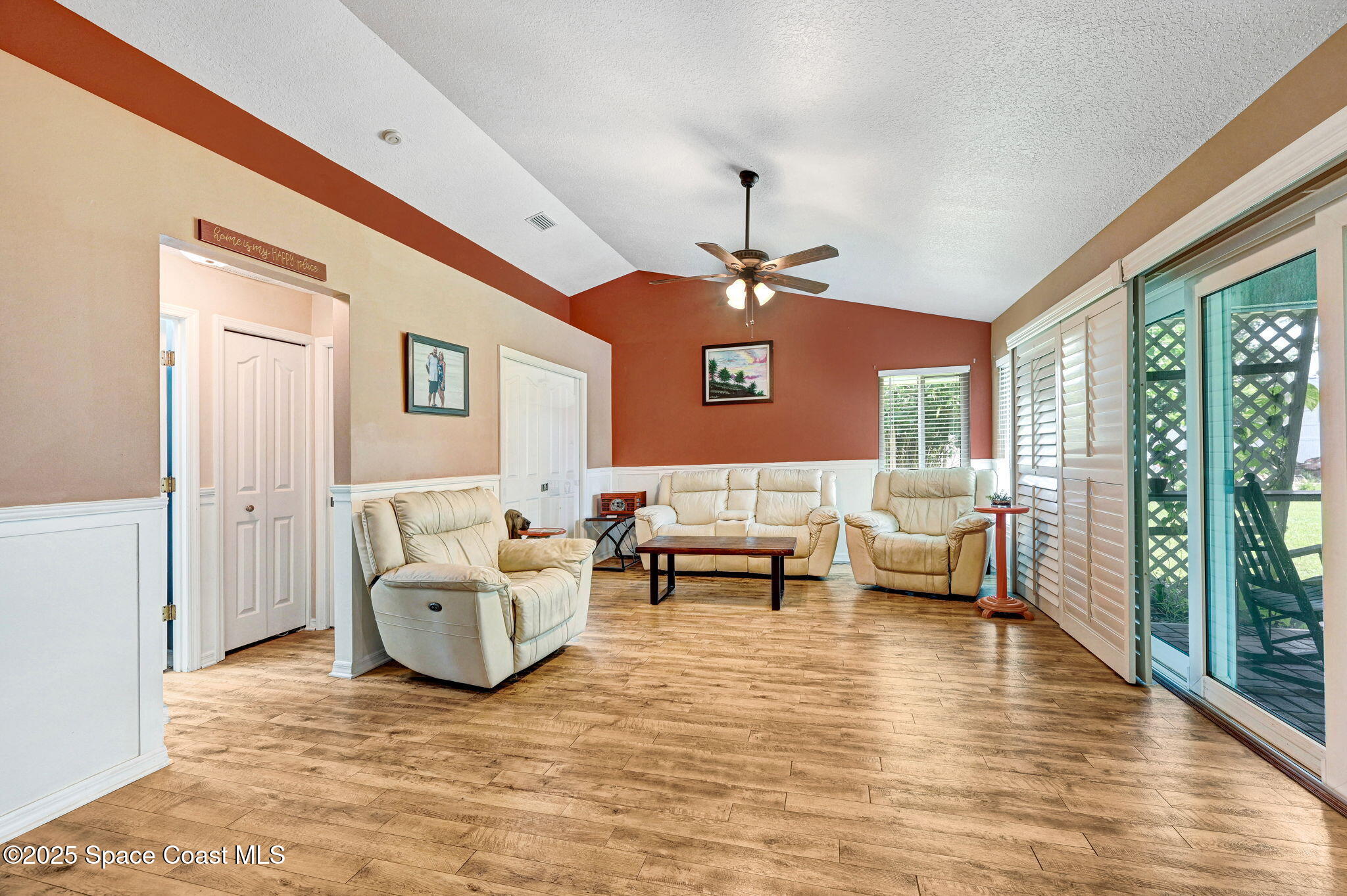1507 Meadowbrook Road Northeast Palm Bay, FL 32905 - Photo 22 of 50 a living room with furniture and wooden floor