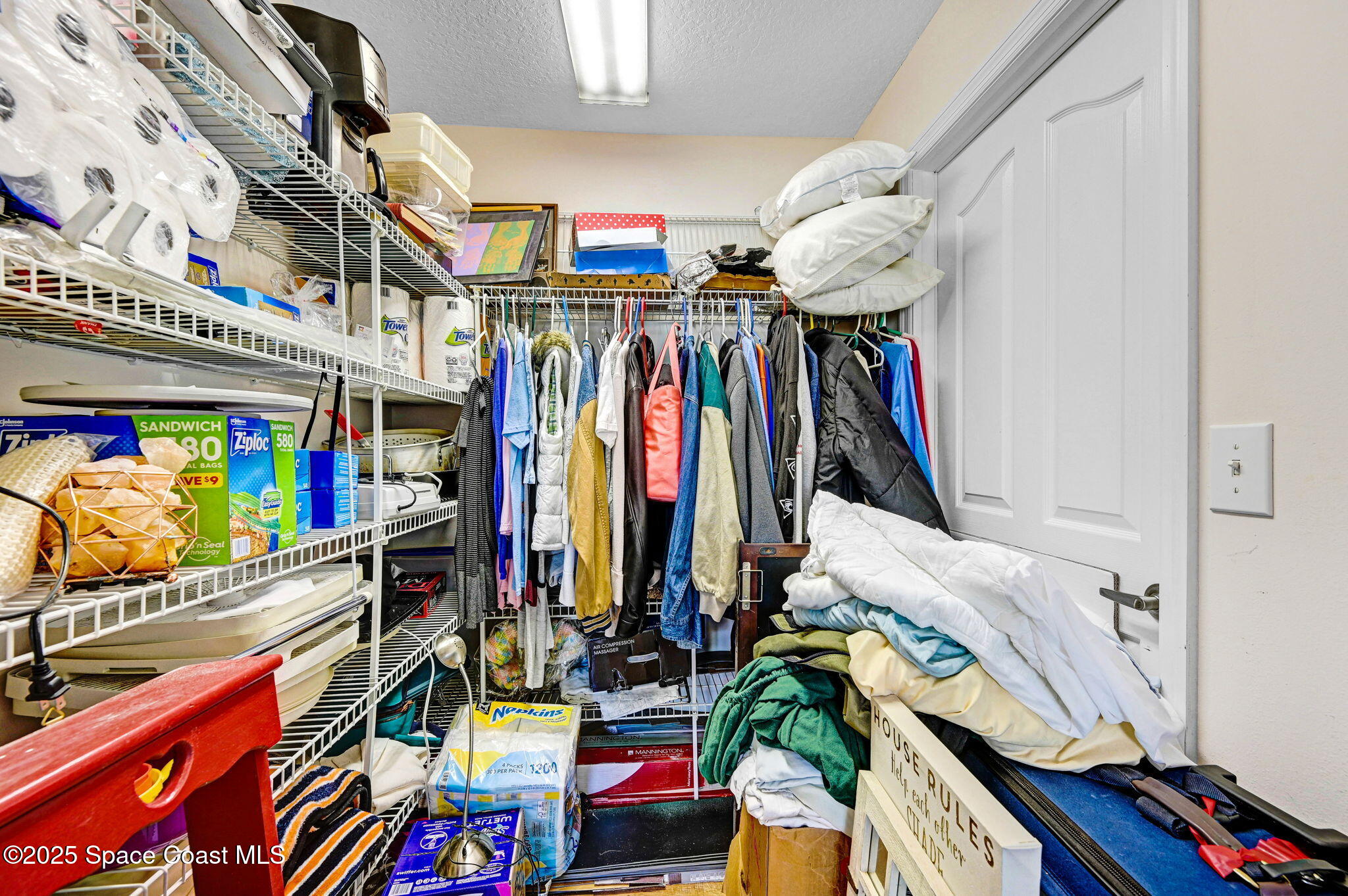 1507 Meadowbrook Road Northeast Palm Bay, FL 32905 - Photo 24 of 50 a view of walk in closet with clothes