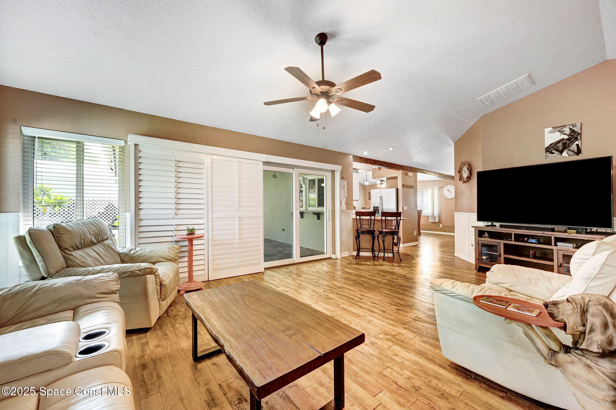 1507 Meadowbrook Road Northeast Palm Bay, FL 32905 - Photo 28 of 50 a living room with furniture and a flat screen tv