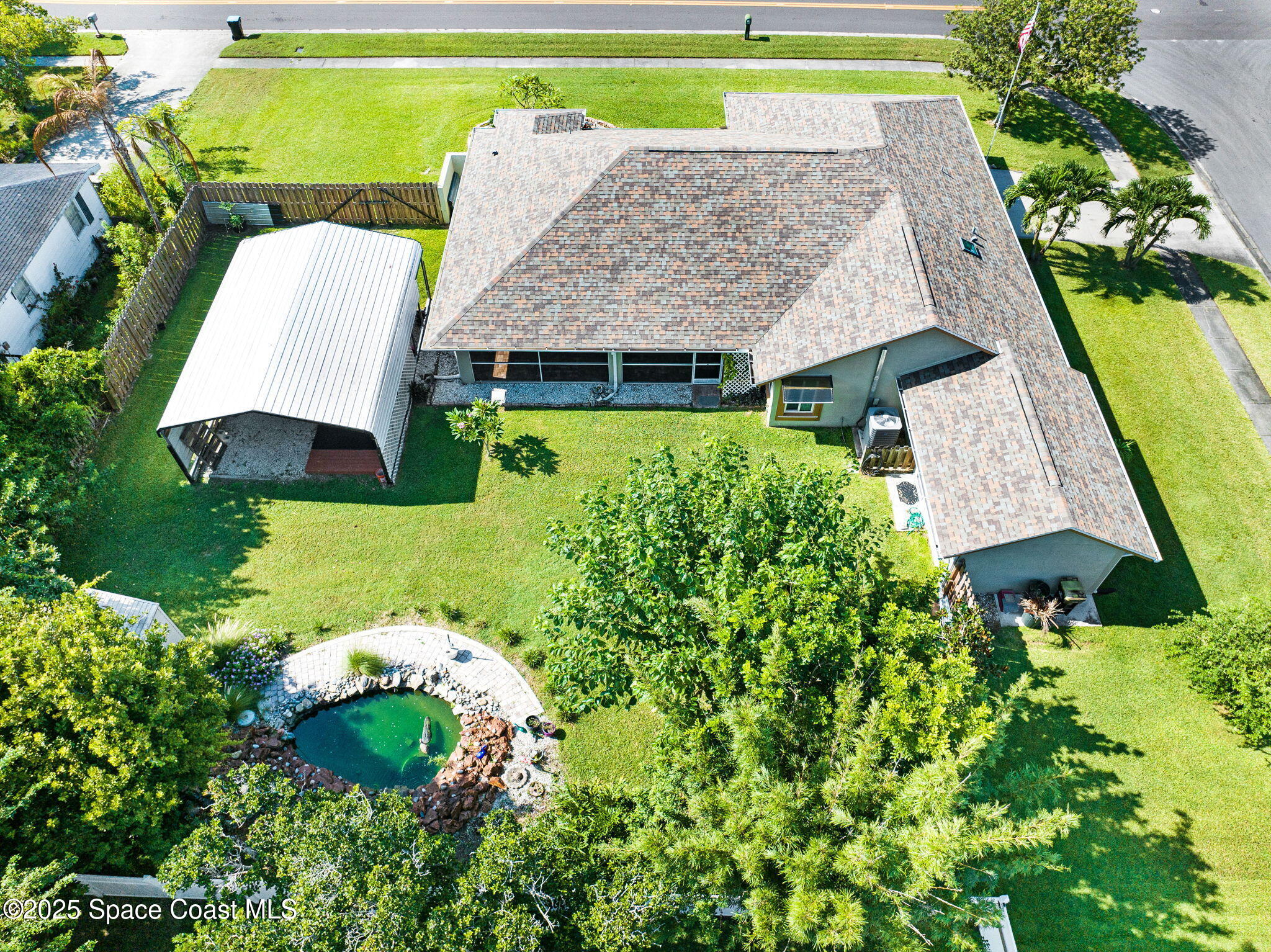 1507 Meadowbrook Road Northeast Palm Bay, FL 32905 - Photo 3 of 50 an aerial view of a house with garden space and street view