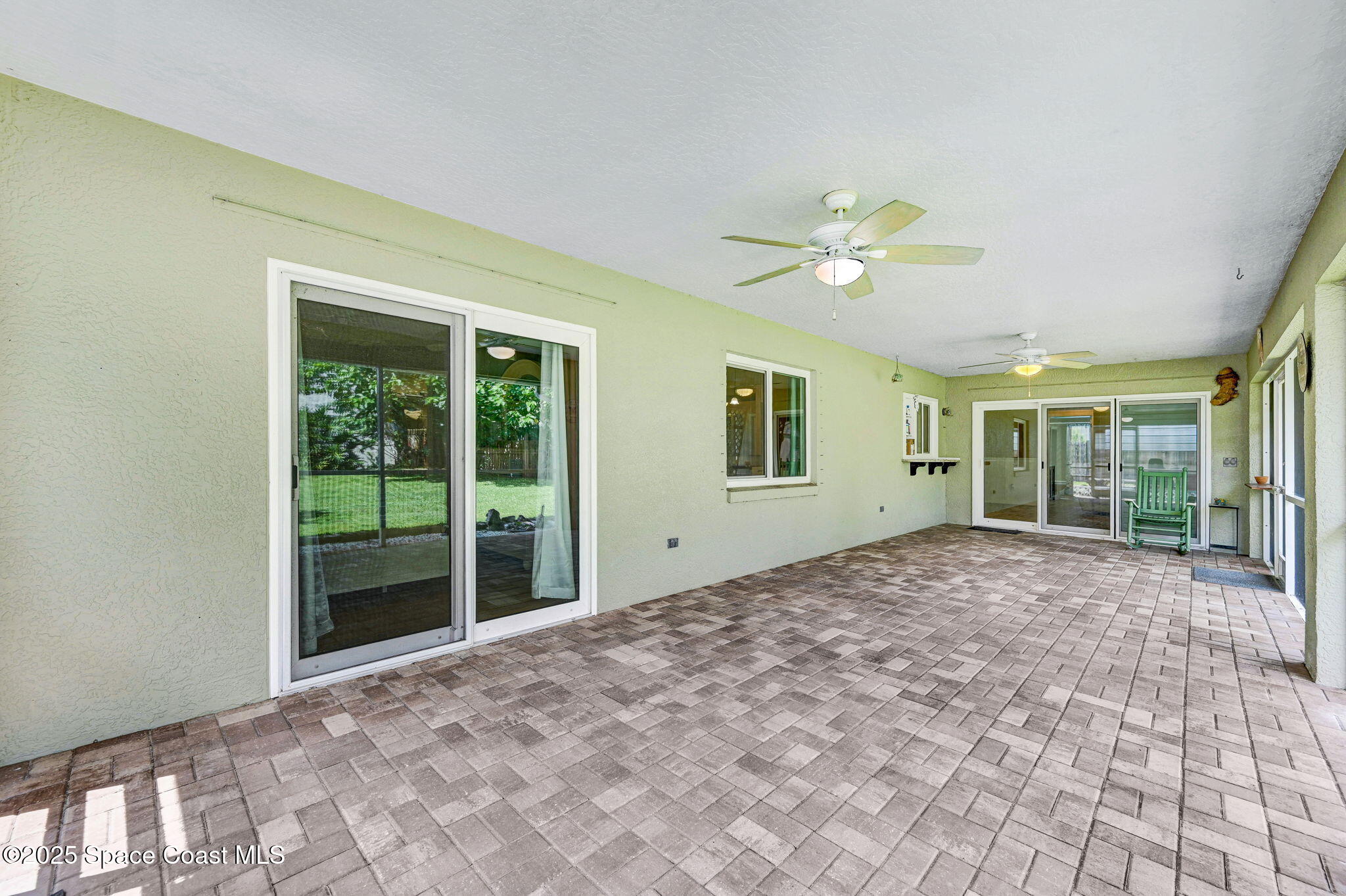1507 Meadowbrook Road Northeast Palm Bay, FL 32905 - Photo 31 of 50 a view of an empty room with a ceiling fan and window