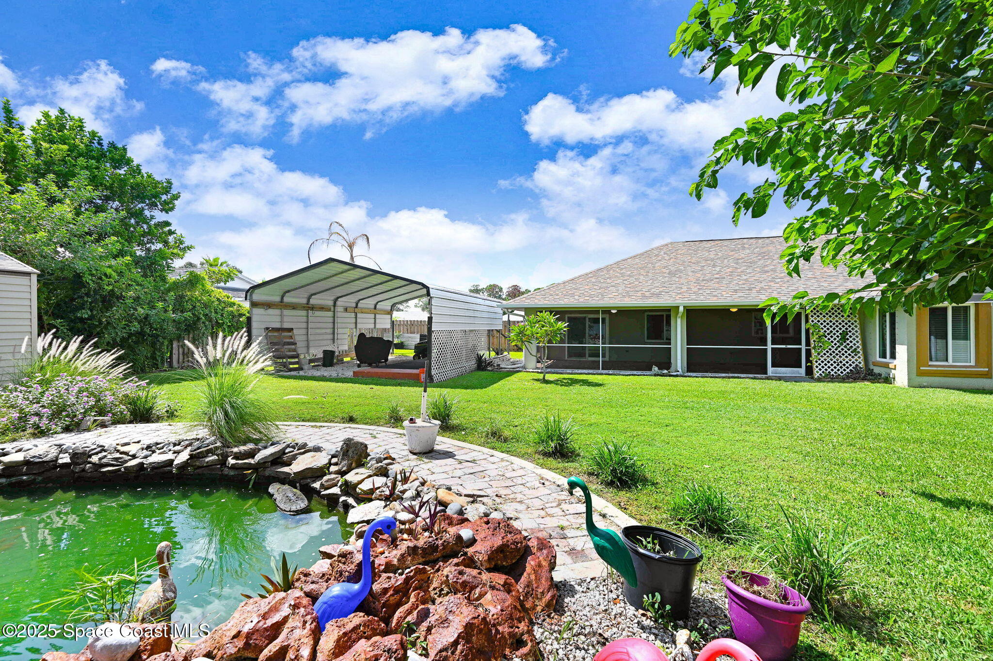 1507 Meadowbrook Road Northeast Palm Bay, FL 32905 - Photo 33 of 50 a front view of a house with garden