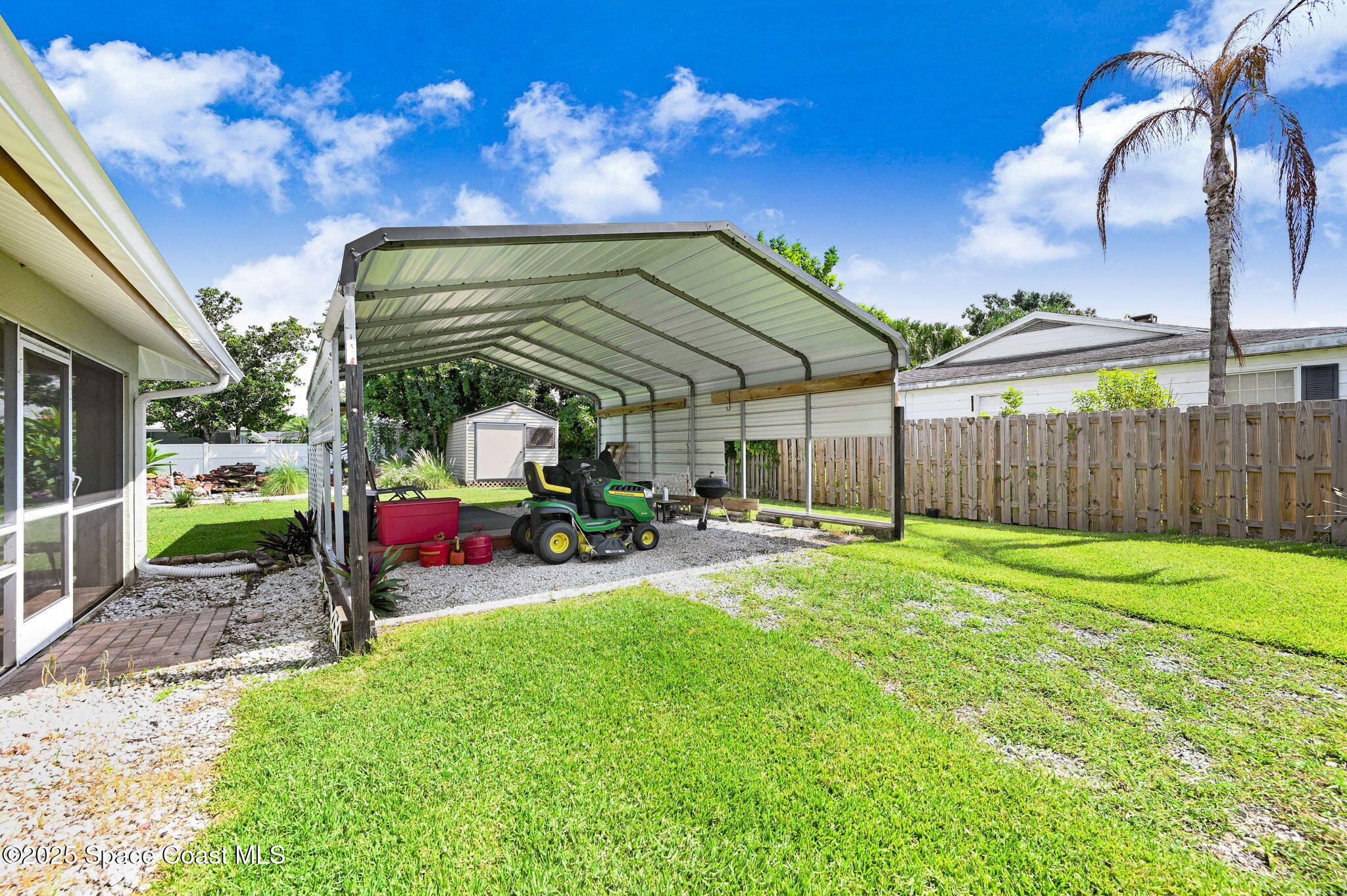 1507 Meadowbrook Road Northeast Palm Bay, FL 32905 - Photo 35 of 50 a view of a chair and table in the back yard of the house
