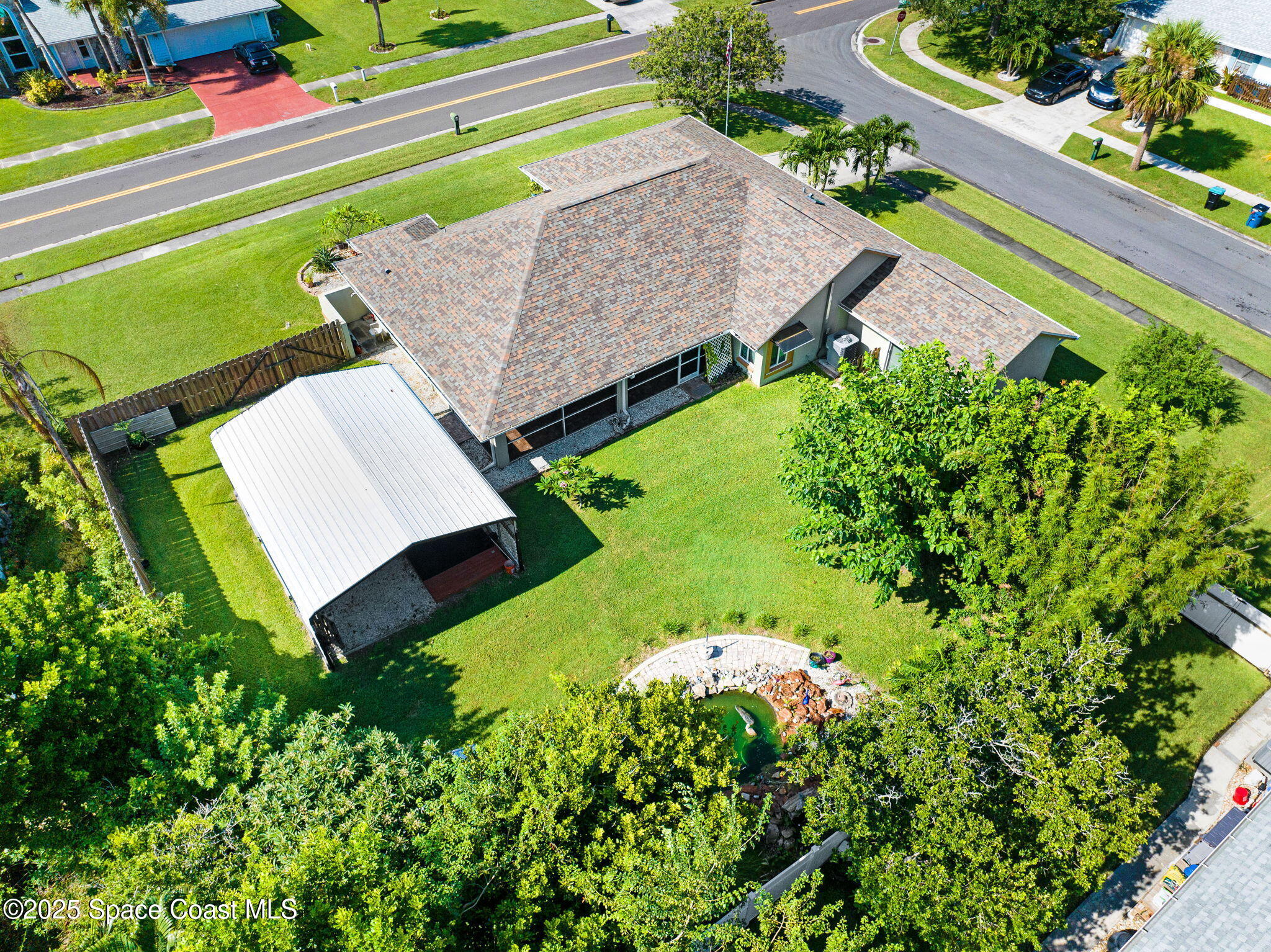 1507 Meadowbrook Road Northeast Palm Bay, FL 32905 - Photo 36 of 50 an aerial view of a house with a garden